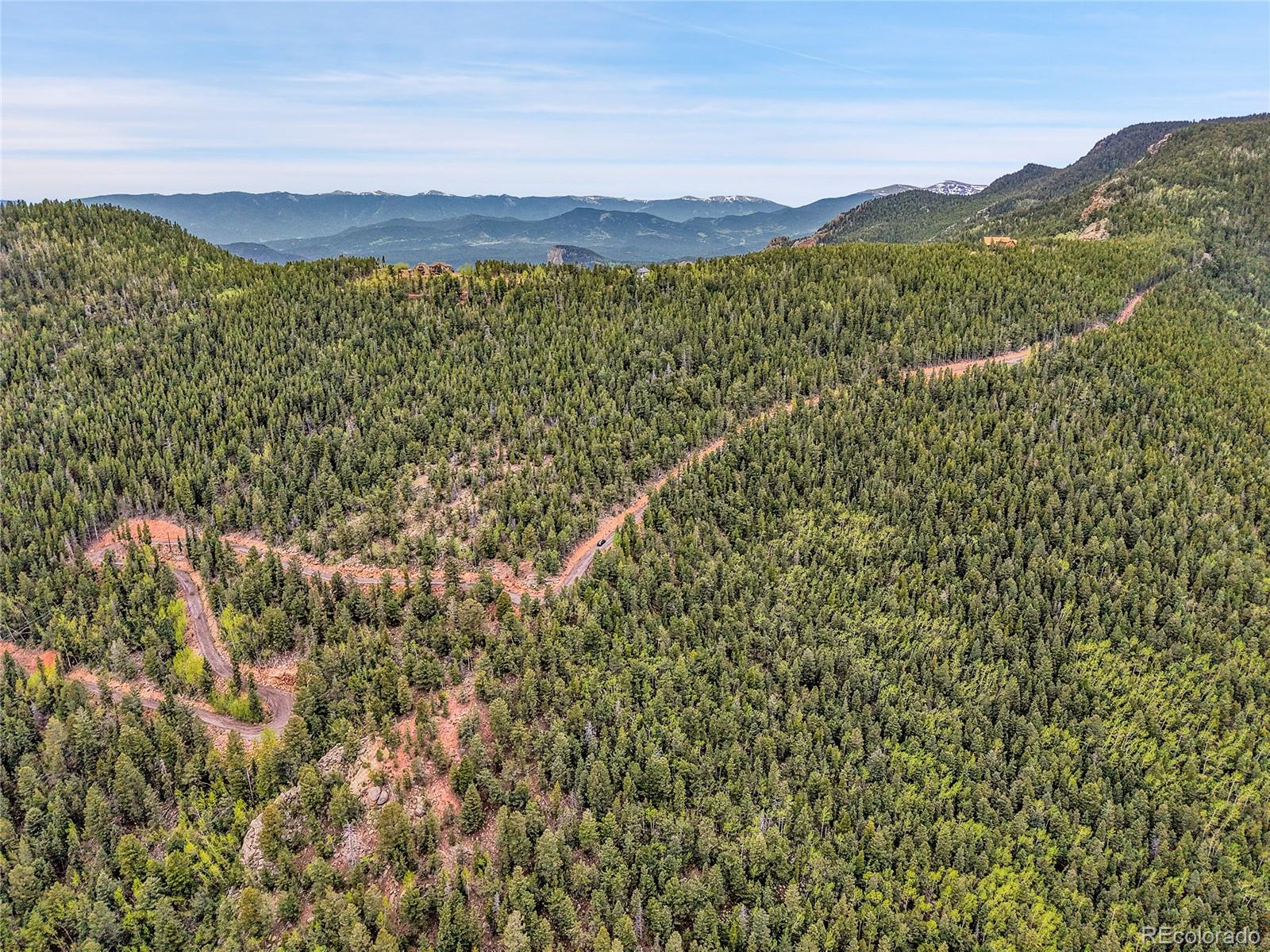 0 Mule Slide Trail Conifer, CO 80433 - Photo 29 of 40 a view of a lush green hillside and a building