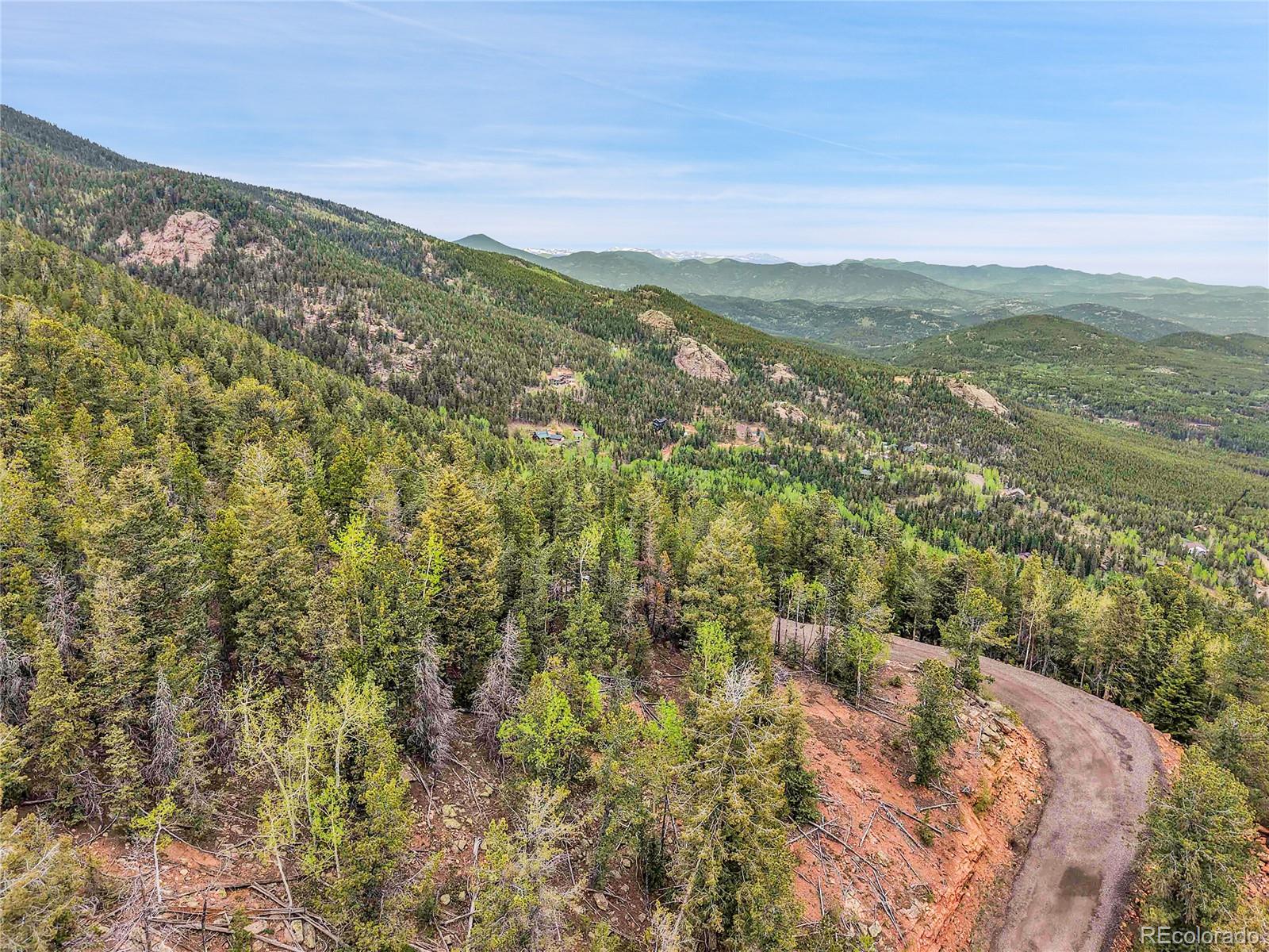 0 Mule Slide Trail Conifer, CO 80433 - Photo 35 of 40 a view of a city with mountains in the background