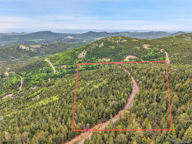 a view of a lush green field with a lake