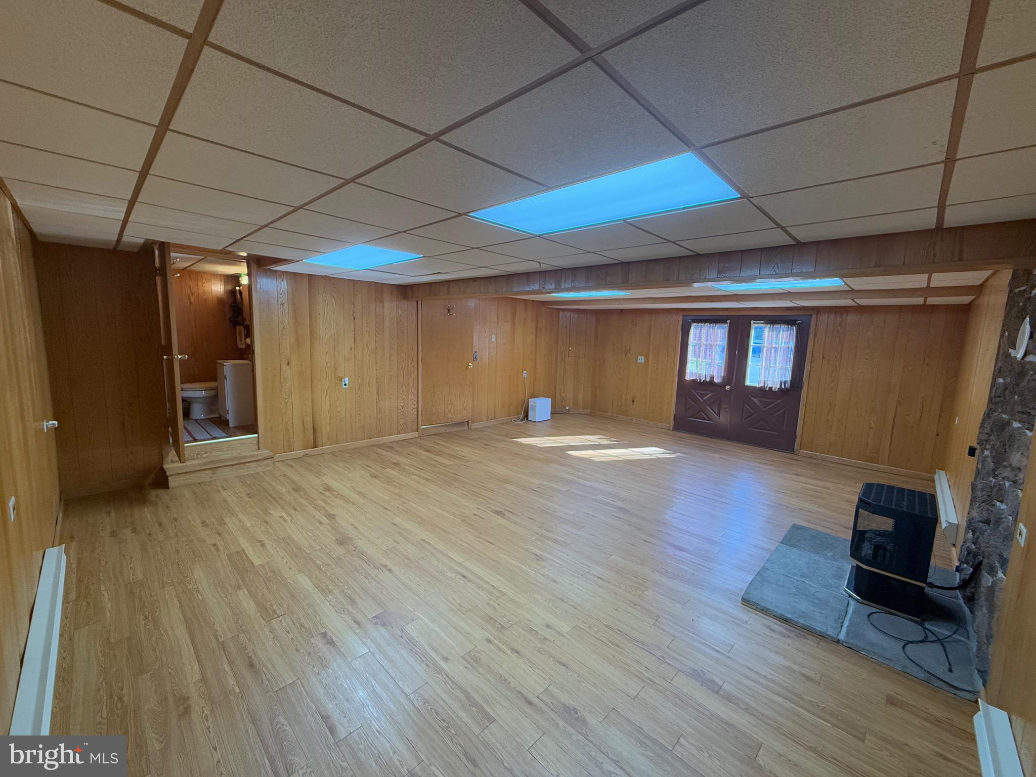 15660 Smith Valley Road Mapleton Depot, PA 17052 - Photo 10 of 118 a view of empty room with wooden floor and fireplace