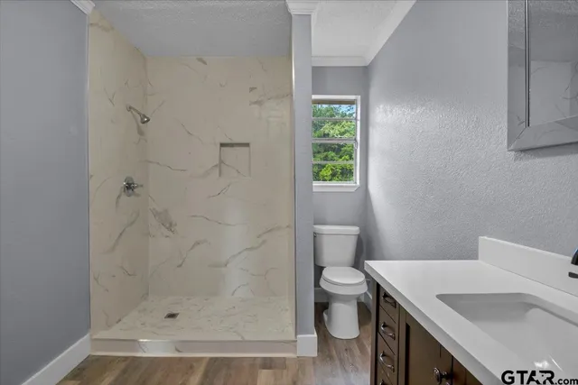 a bathroom with a sink toilet and shower