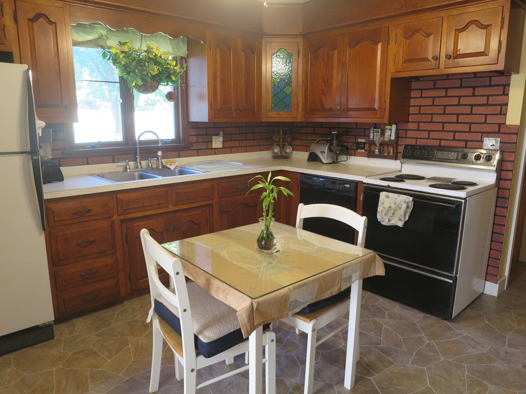 2144 Palmer Road Three Rivers, MA 01080 - Photo 4 of 22 a kitchen with a table chairs sink and cabinets