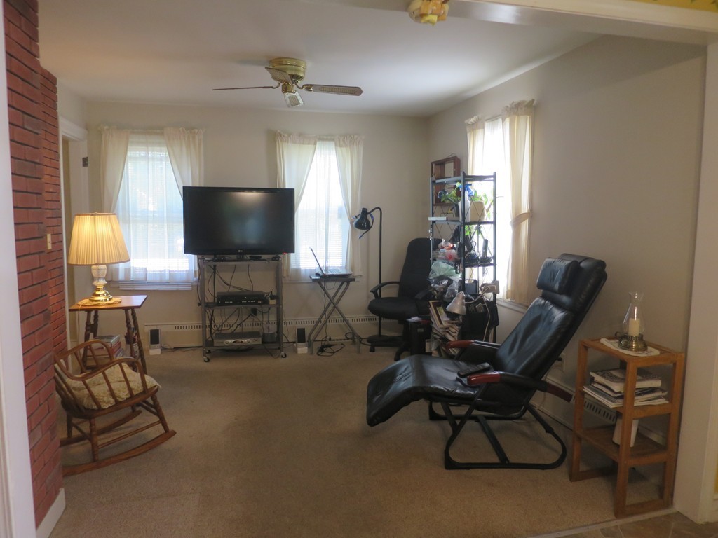 2144 Palmer Road Three Rivers, MA 01080 - Photo 6 of 22 a living room with furniture a chandelier and a flat screen tv