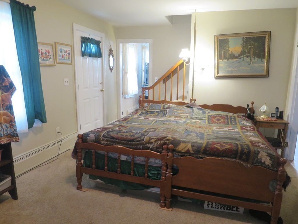 2144 Palmer Road Three Rivers, MA 01080 - Photo 10 of 22 a bedroom with a bed and a chandelier