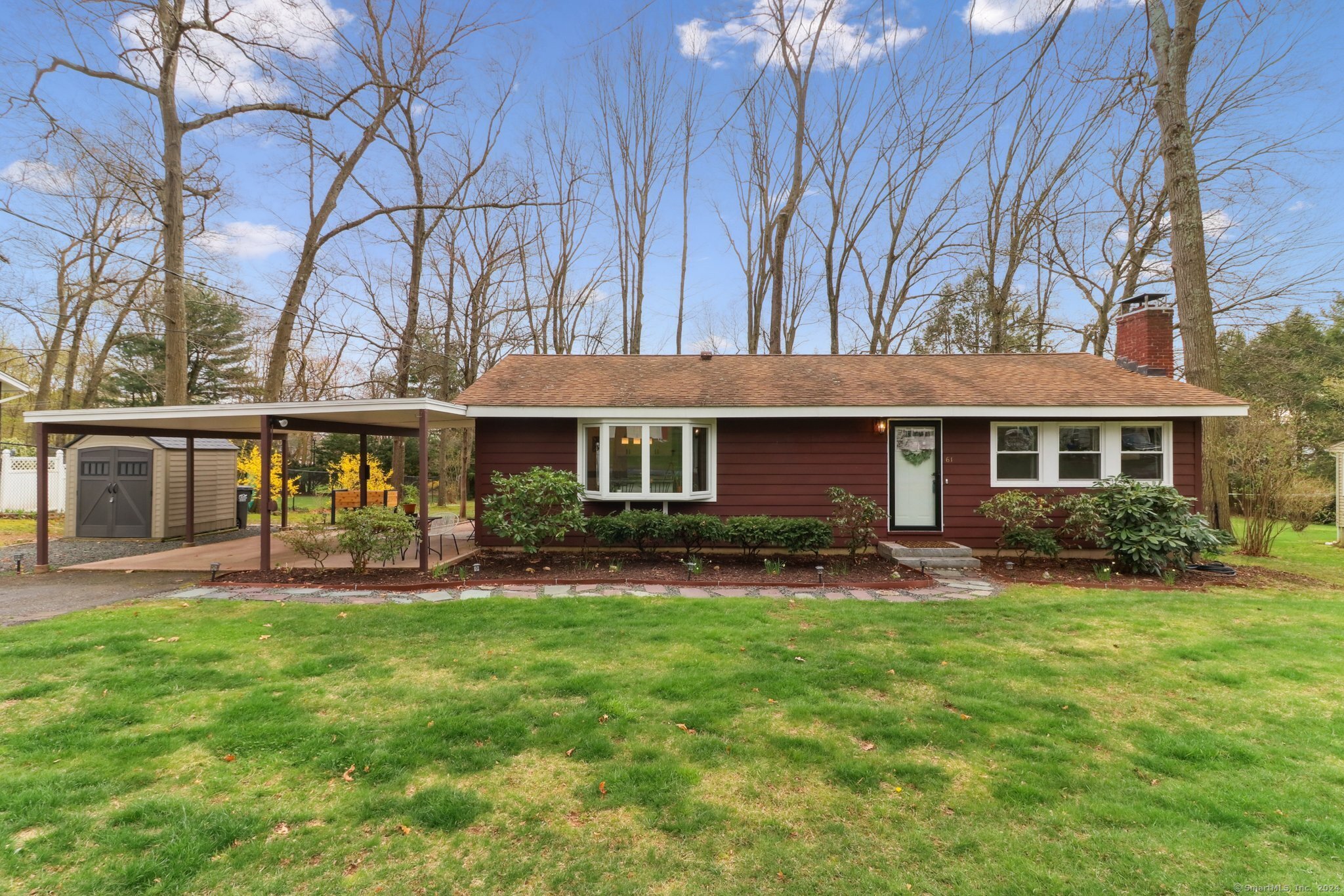 Immaculately maintained exterior showcasing beautiful landscaping and curb appeal.