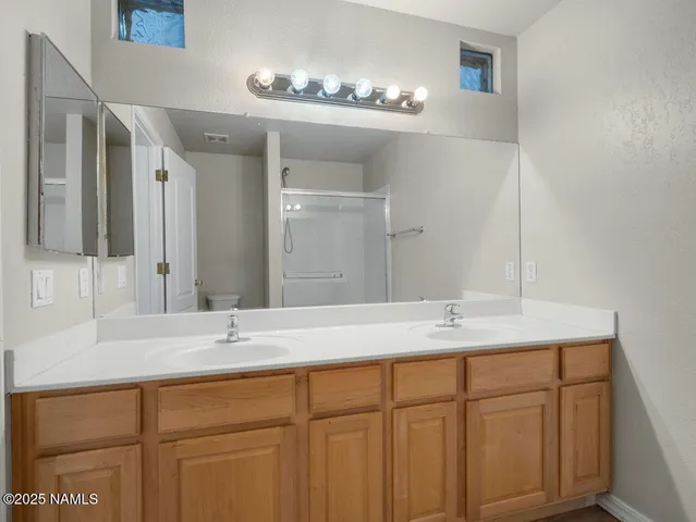 a bathroom with a glass shower door