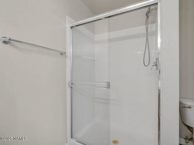 a kitchen with granite countertop a sink cabinets and wooden floor