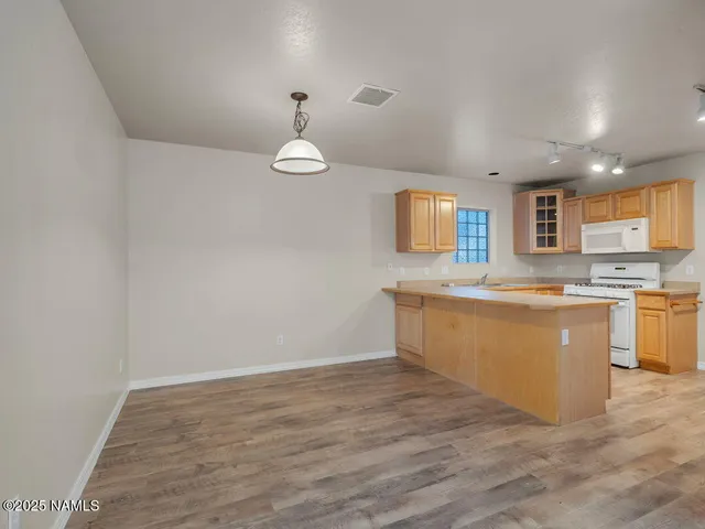a view of kitchen with cabinets and wooden floor