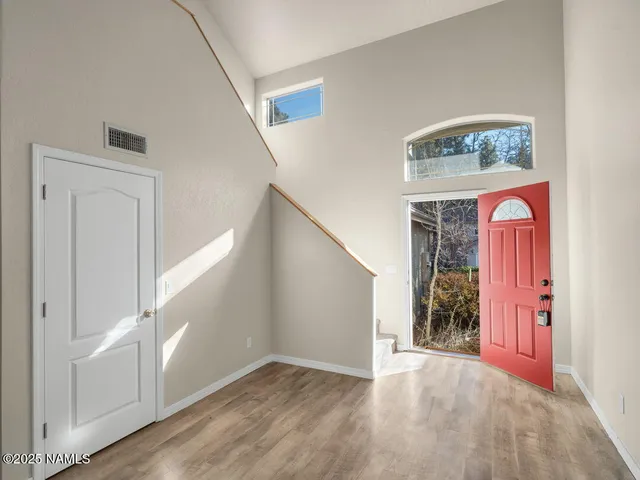 a view of an entryway with wooden floor