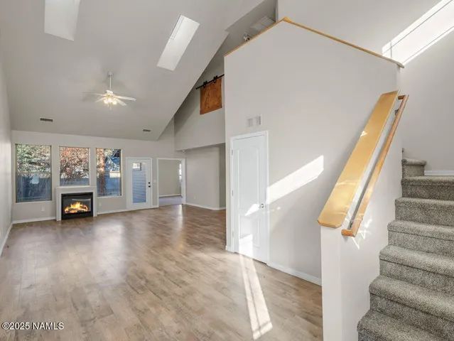a view of an empty room with a fireplace and a large window