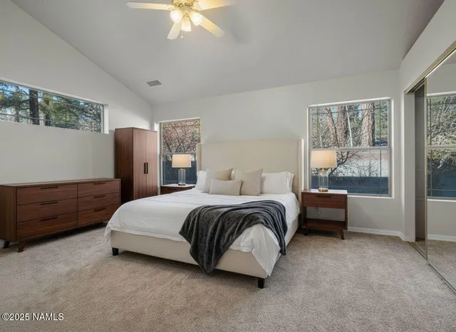 an empty room with windows and closet