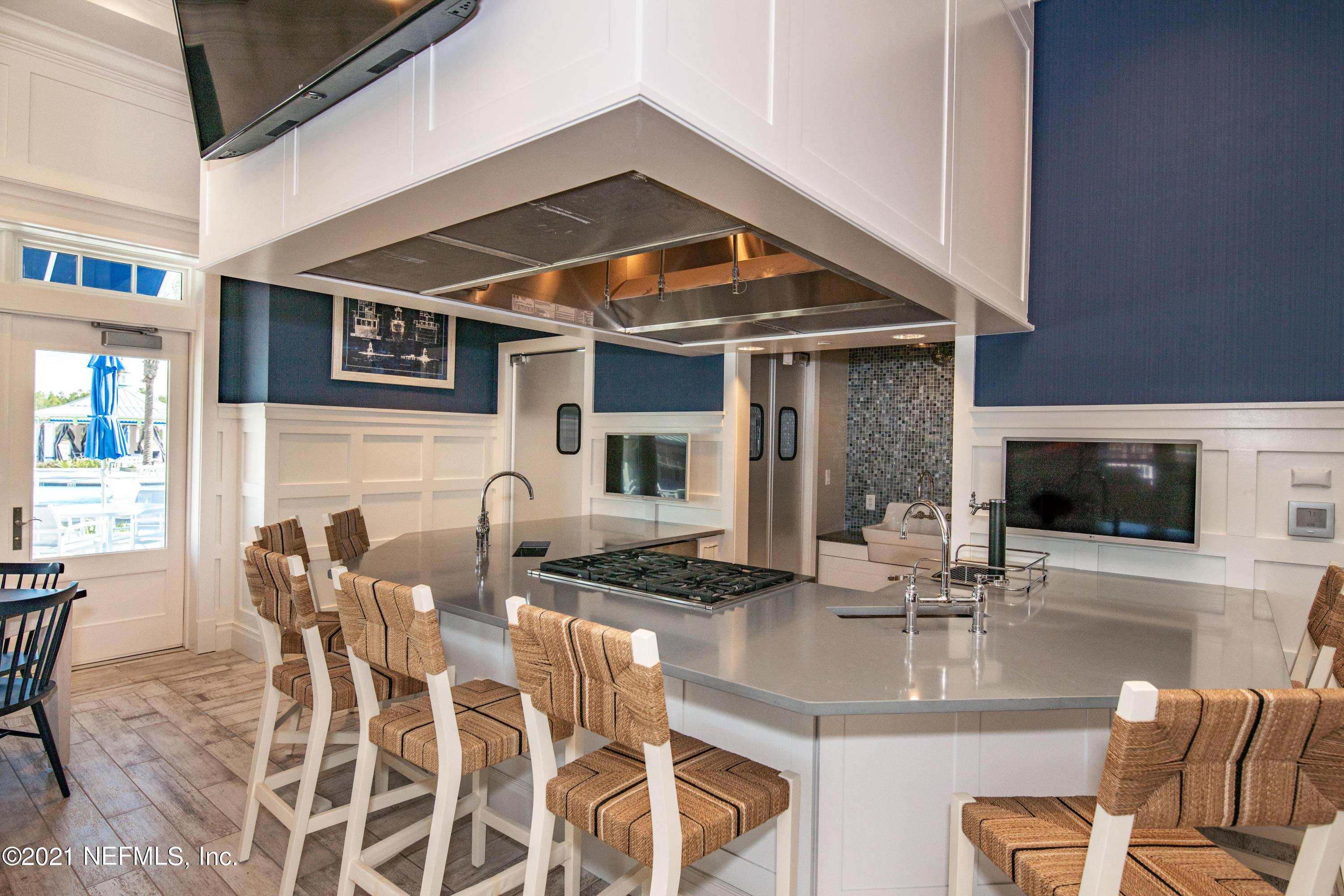 319 Charlie Way St. Augustine, FL 32095 - Photo 23 of 36 a kitchen with stainless steel appliances kitchen island granite countertop a table and chairs