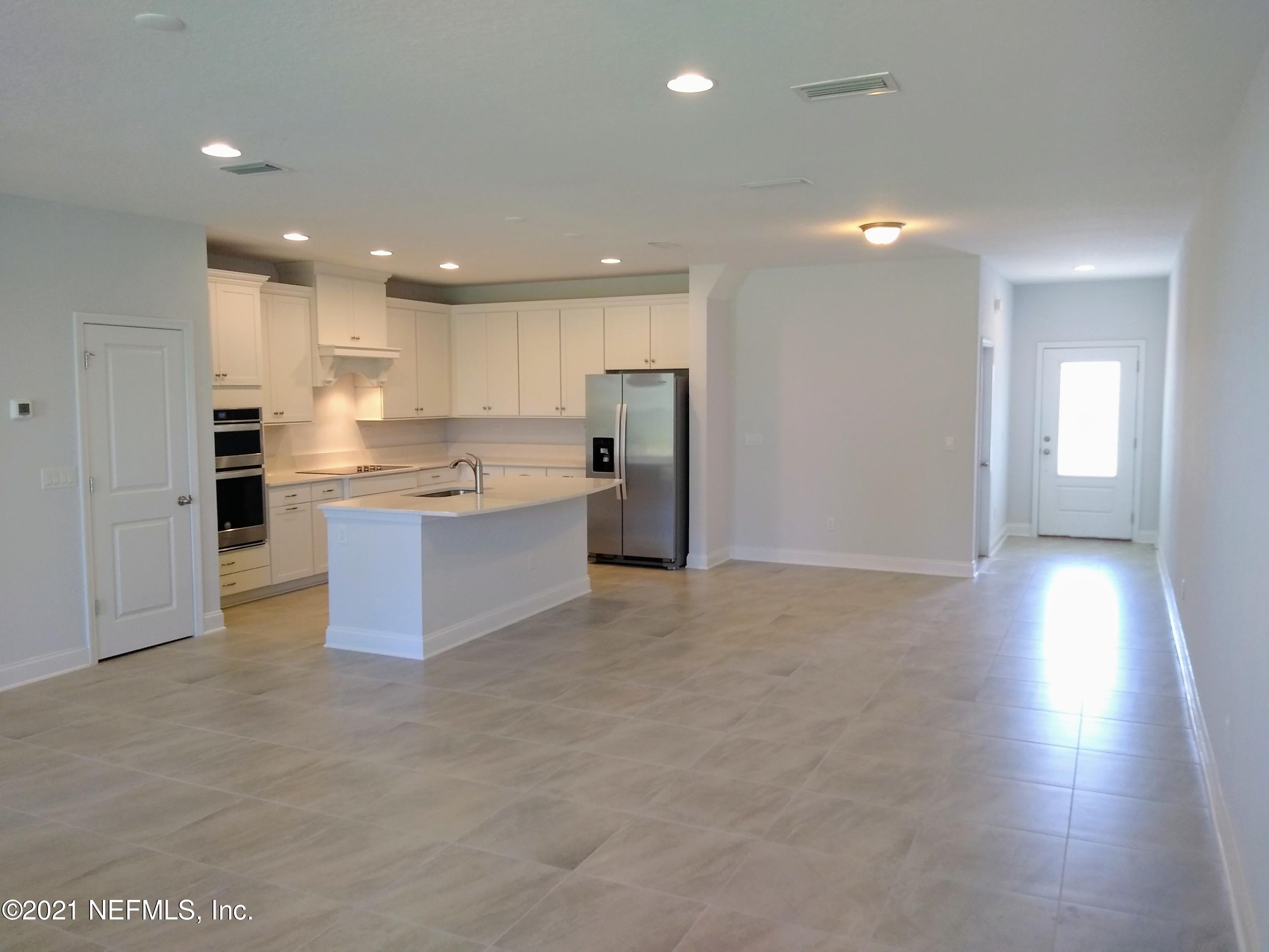 319 Charlie Way St. Augustine, FL 32095 - Photo 4 of 36 a view of a kitchen with a sink and a refrigerator