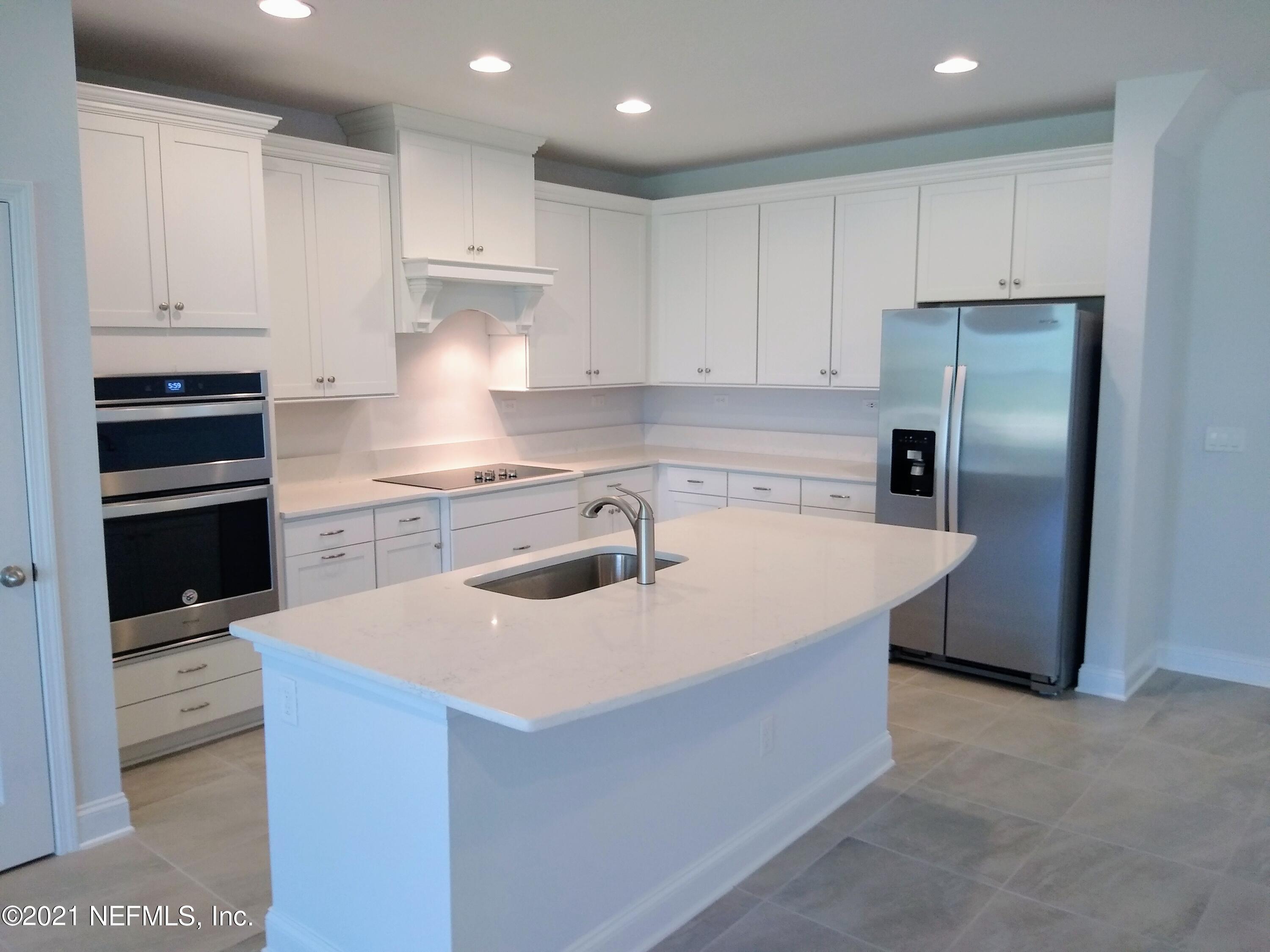 319 Charlie Way St. Augustine, FL 32095 - Photo 5 of 36 a kitchen with kitchen island sink stove and refrigerator