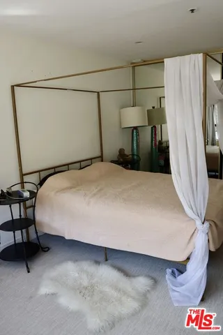 a large bed sitting in a bathroom