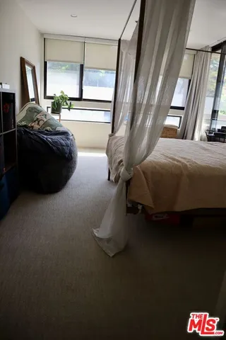 a bedroom with bed and window