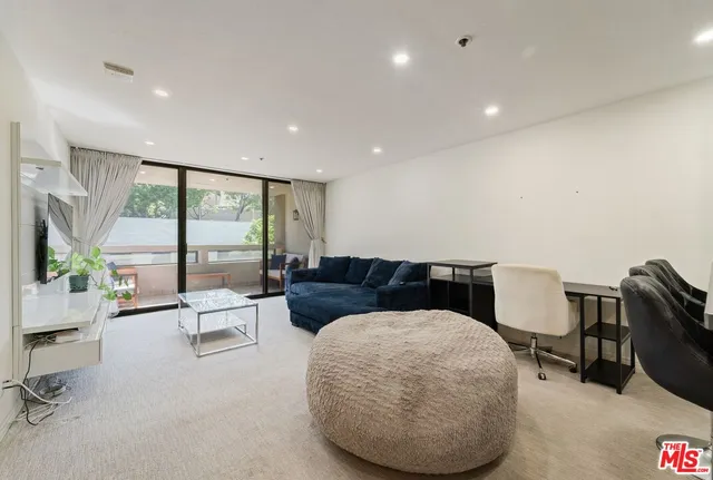 a living room with furniture a table and chairs