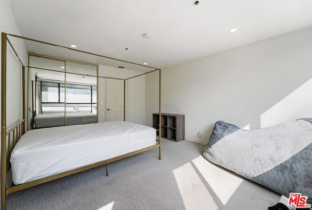 a bedroom with a bed and a walk in closet