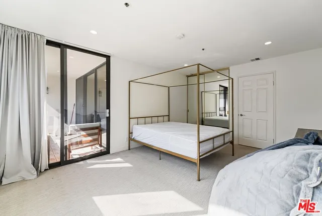 a view of a hallway with bathroom and a bathroom