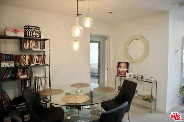 a view of a dining room with furniture and a chandelier