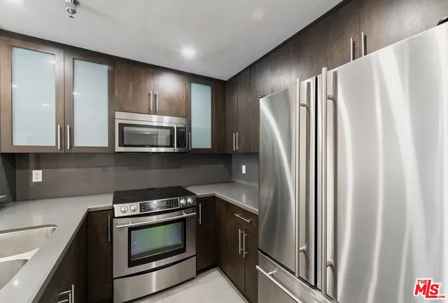 a living room with furniture and kitchen view