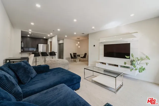 a view of a livingroom with workspace and a flat screen tv