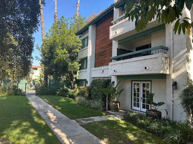 a view of a car park front of a house