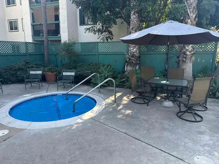 a view of backyard with swimming pool and outdoor seating