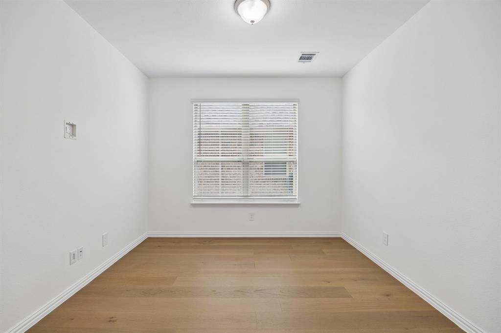 1303 Wheelwright Drive Forney, TX 75126 - Photo 20 of 39 Room featuring light wood-finish flooring, white baseboards, and a single window with blinds