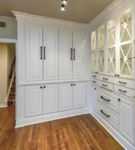 an empty room with windows and closet