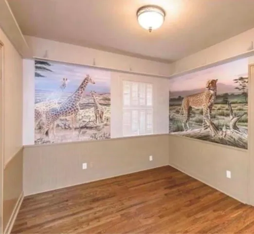 an empty room with windows and cabinet