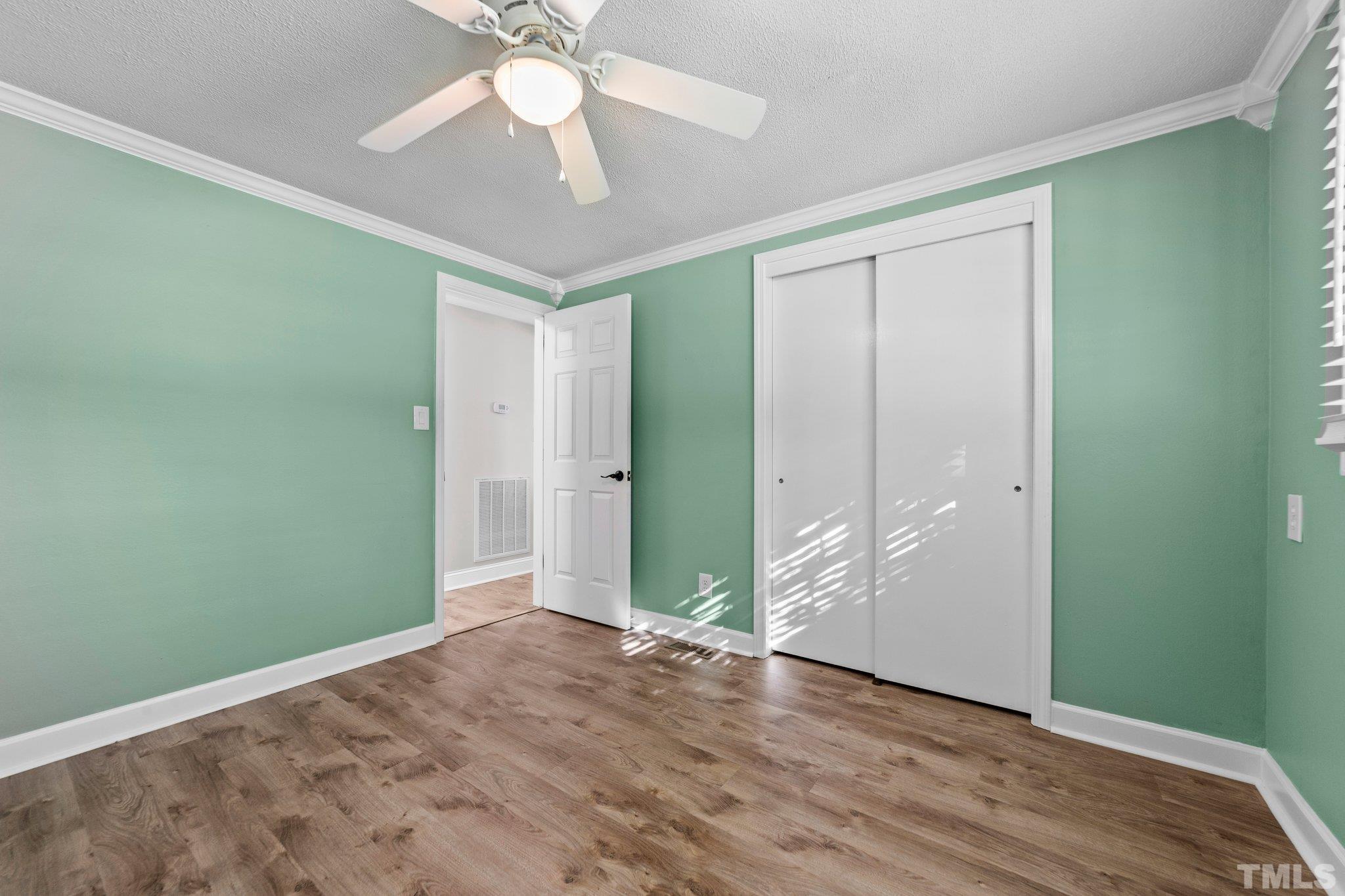 774 Abbott Road Henderson, NC 27537 - Photo 11 of 41 an empty room with fan closet and windows