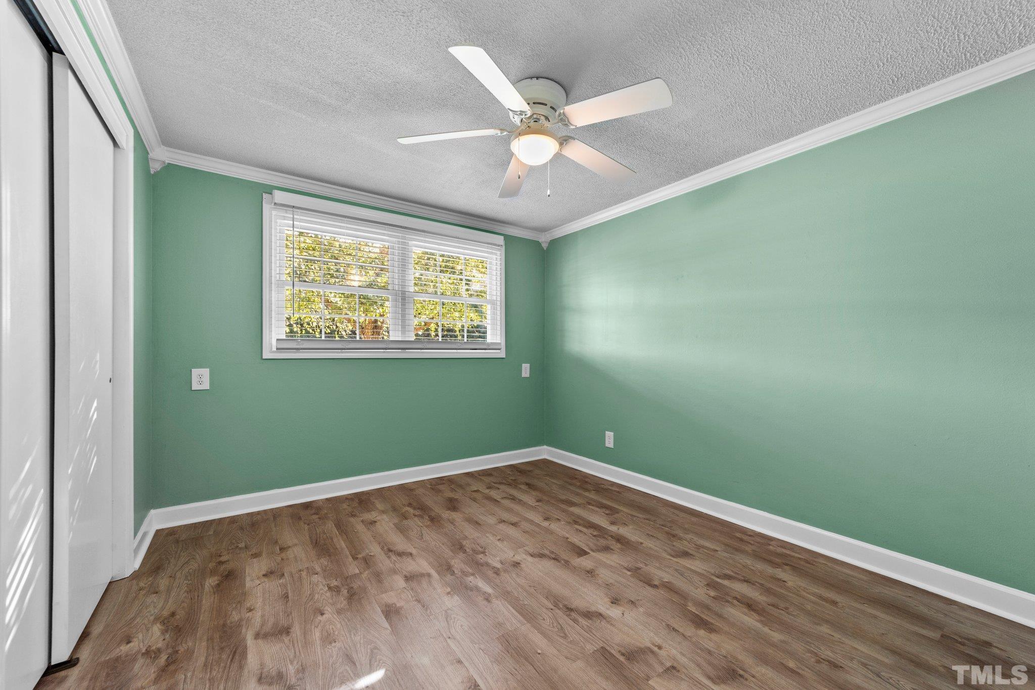 774 Abbott Road Henderson, NC 27537 - Photo 12 of 41 wooden floor in an empty room with a window