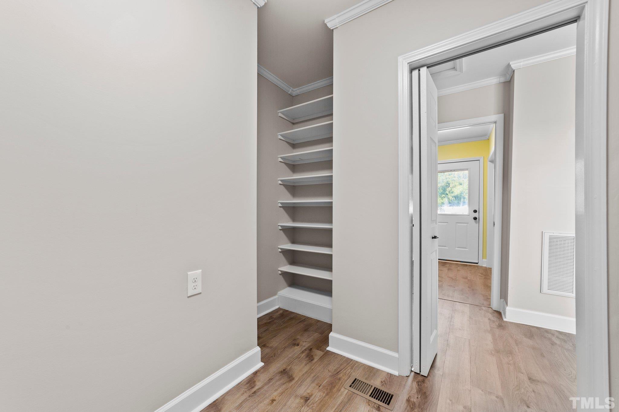 774 Abbott Road Henderson, NC 27537 - Photo 14 of 41 a view of an empty room with wooden floor and a window