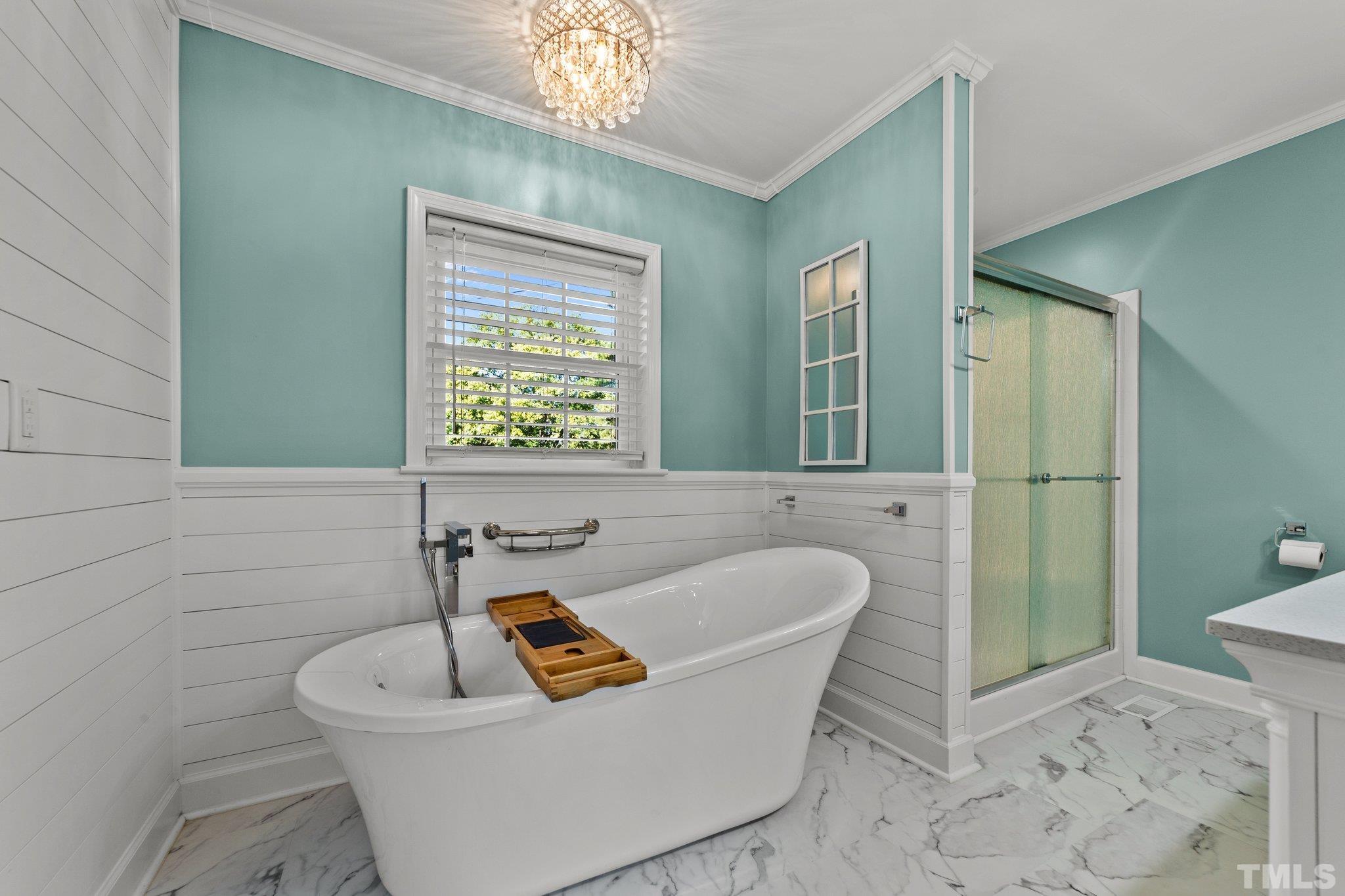 774 Abbott Road Henderson, NC 27537 - Photo 15 of 41 a bath room with a toilet a bath tub and a potted plant