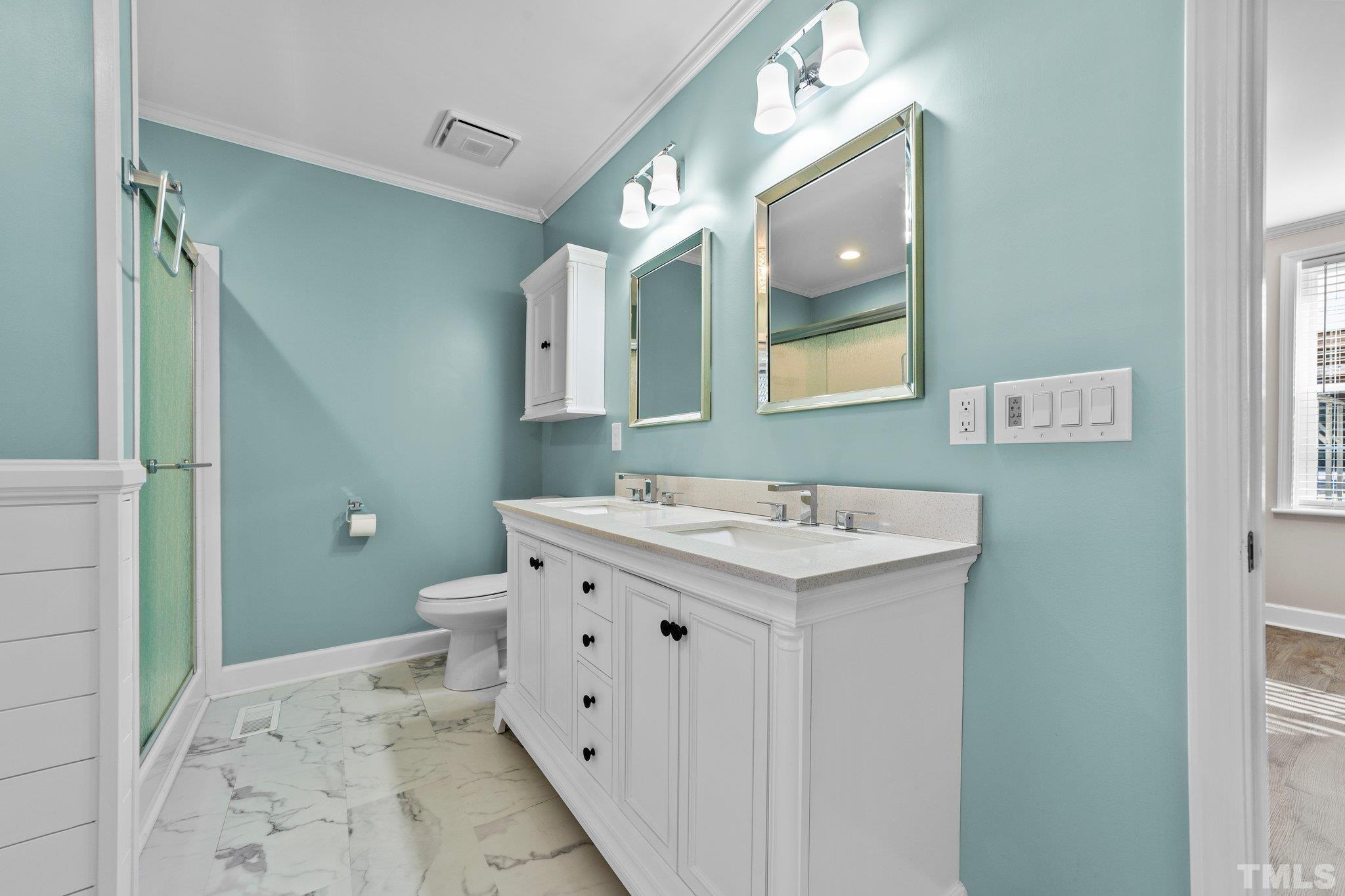 774 Abbott Road Henderson, NC 27537 - Photo 16 of 41 a bathroom with a sink a toilet and mirror