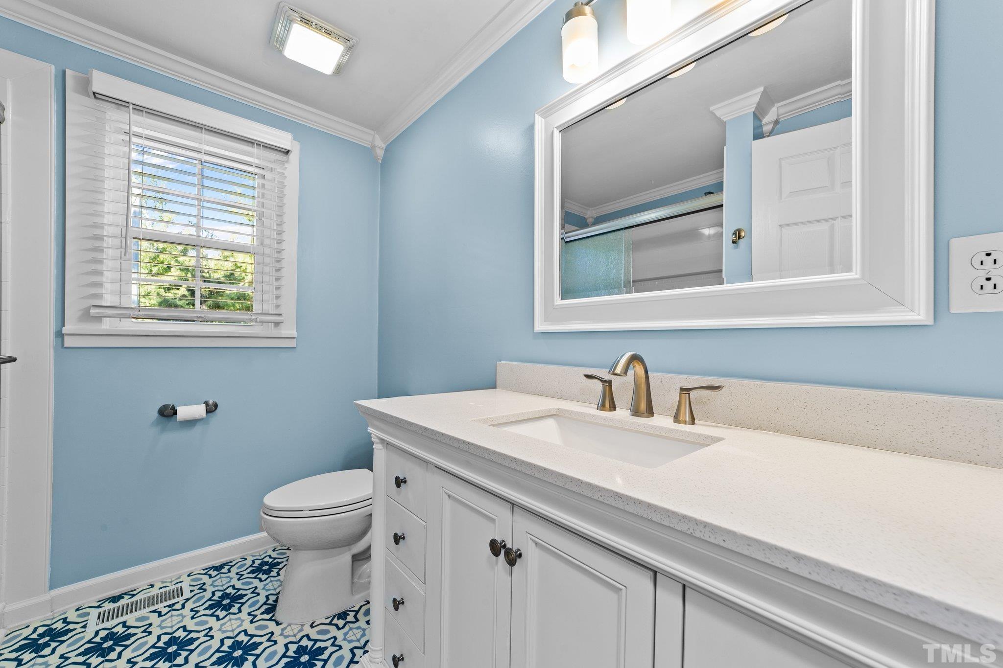 774 Abbott Road Henderson, NC 27537 - Photo 18 of 41 a bathroom with a sink a toilet and a window