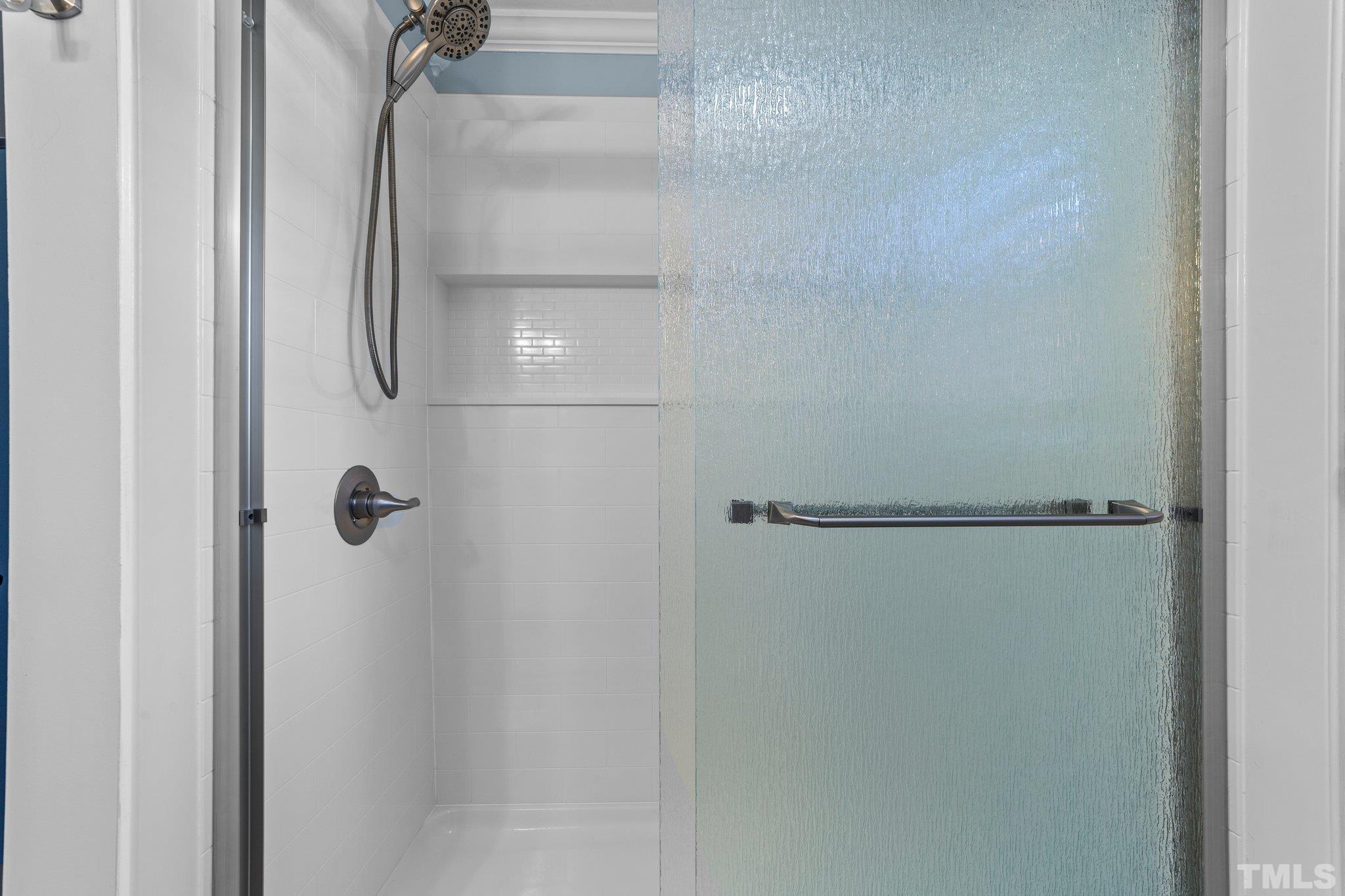 774 Abbott Road Henderson, NC 27537 - Photo 21 of 41 a bathroom with a glass shower door