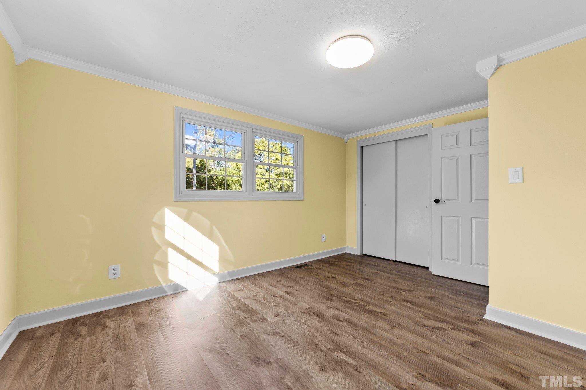 774 Abbott Road Henderson, NC 27537 - Photo 26 of 41 an empty room with wooden floor and windows