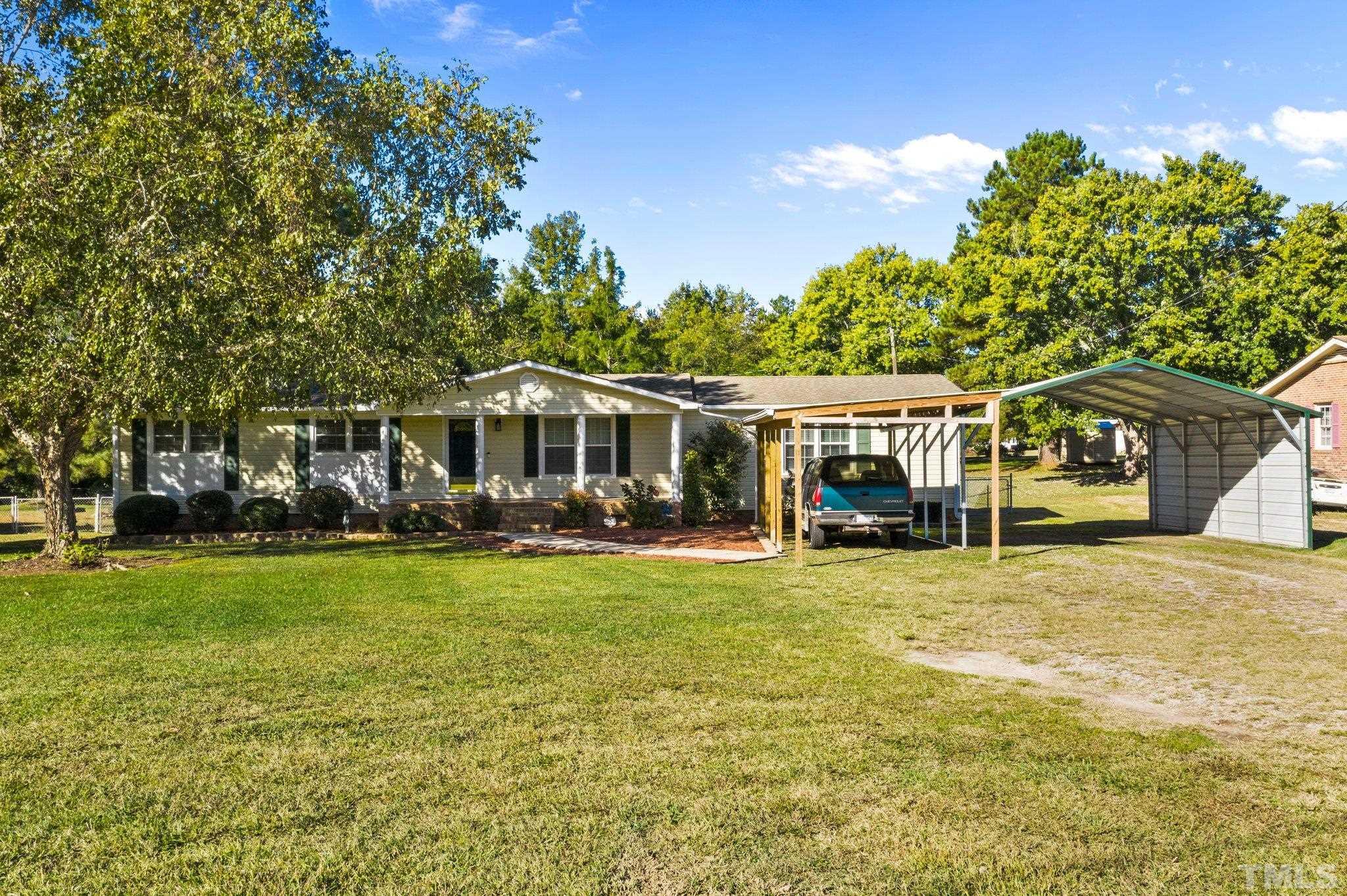 774 Abbott Road Henderson, NC 27537 - Photo 3 of 41 a front view of a house with a garden and porch