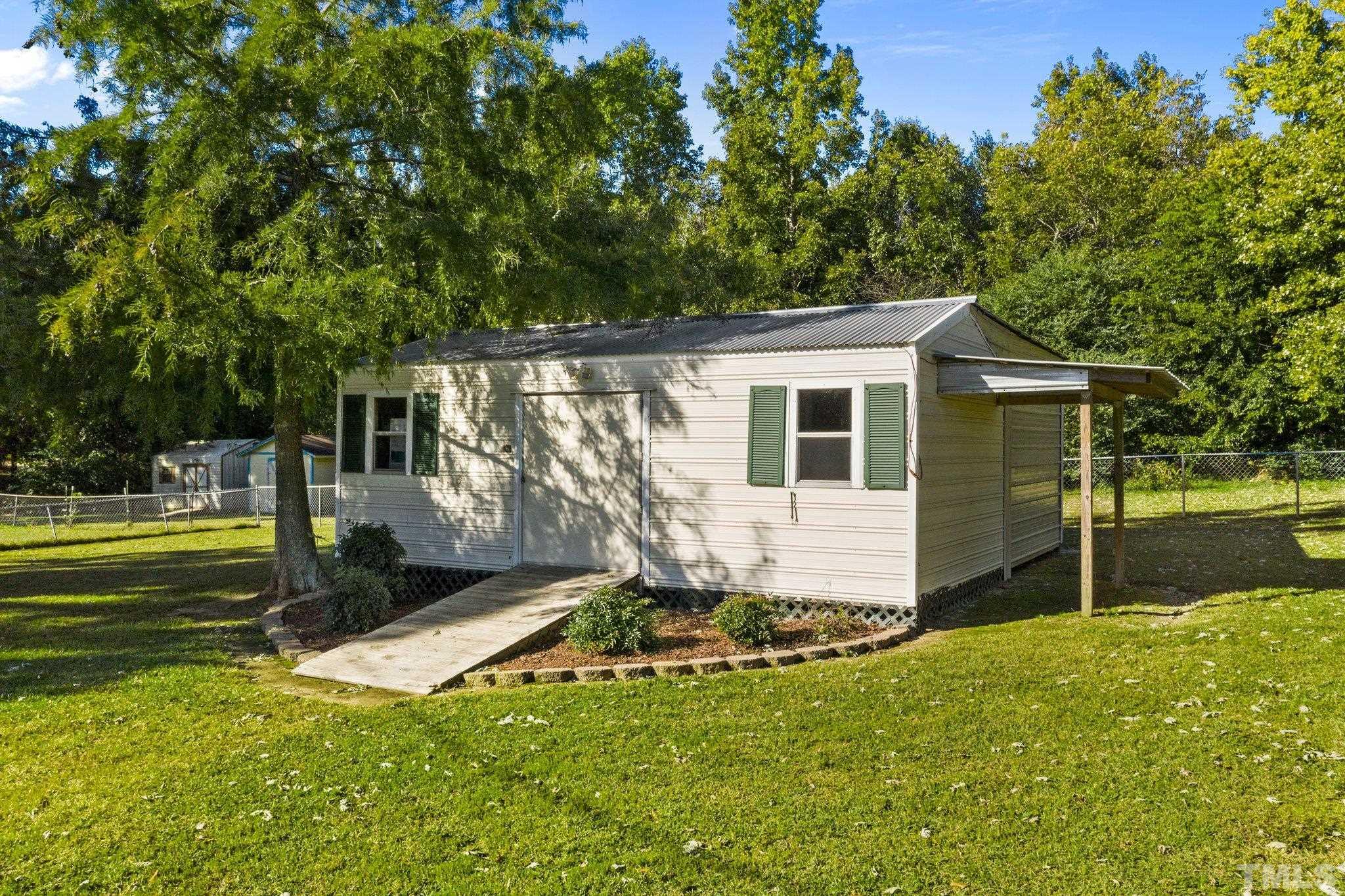 774 Abbott Road Henderson, NC 27537 - Photo 36 of 41 a view of a house with backyard and sitting area