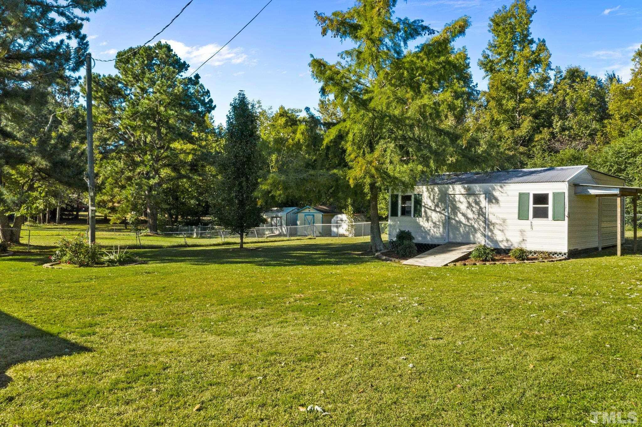774 Abbott Road Henderson, NC 27537 - Photo 37 of 41 a view of swimming pool and trees in the background