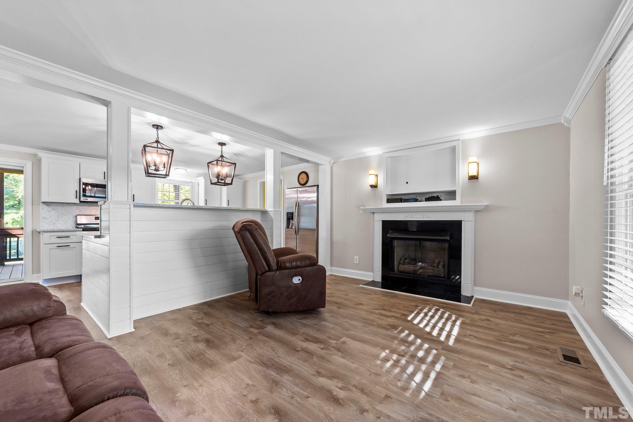 774 Abbott Road Henderson, NC 27537 - Photo 5 of 41 a living room with furniture and a fireplace