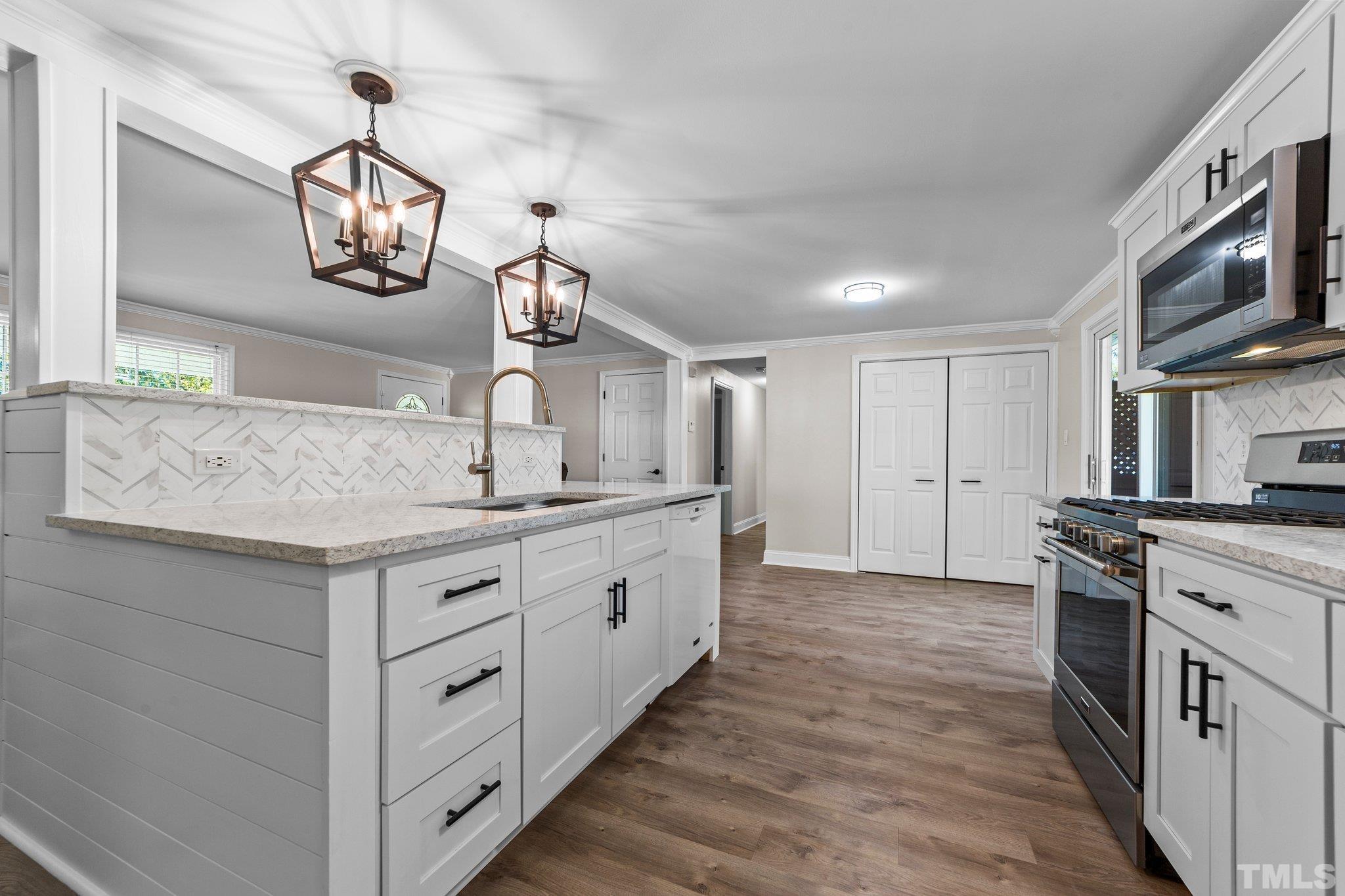 774 Abbott Road Henderson, NC 27537 - Photo 7 of 41 a kitchen with stainless steel appliances granite countertop a sink a stove and a refrigerator