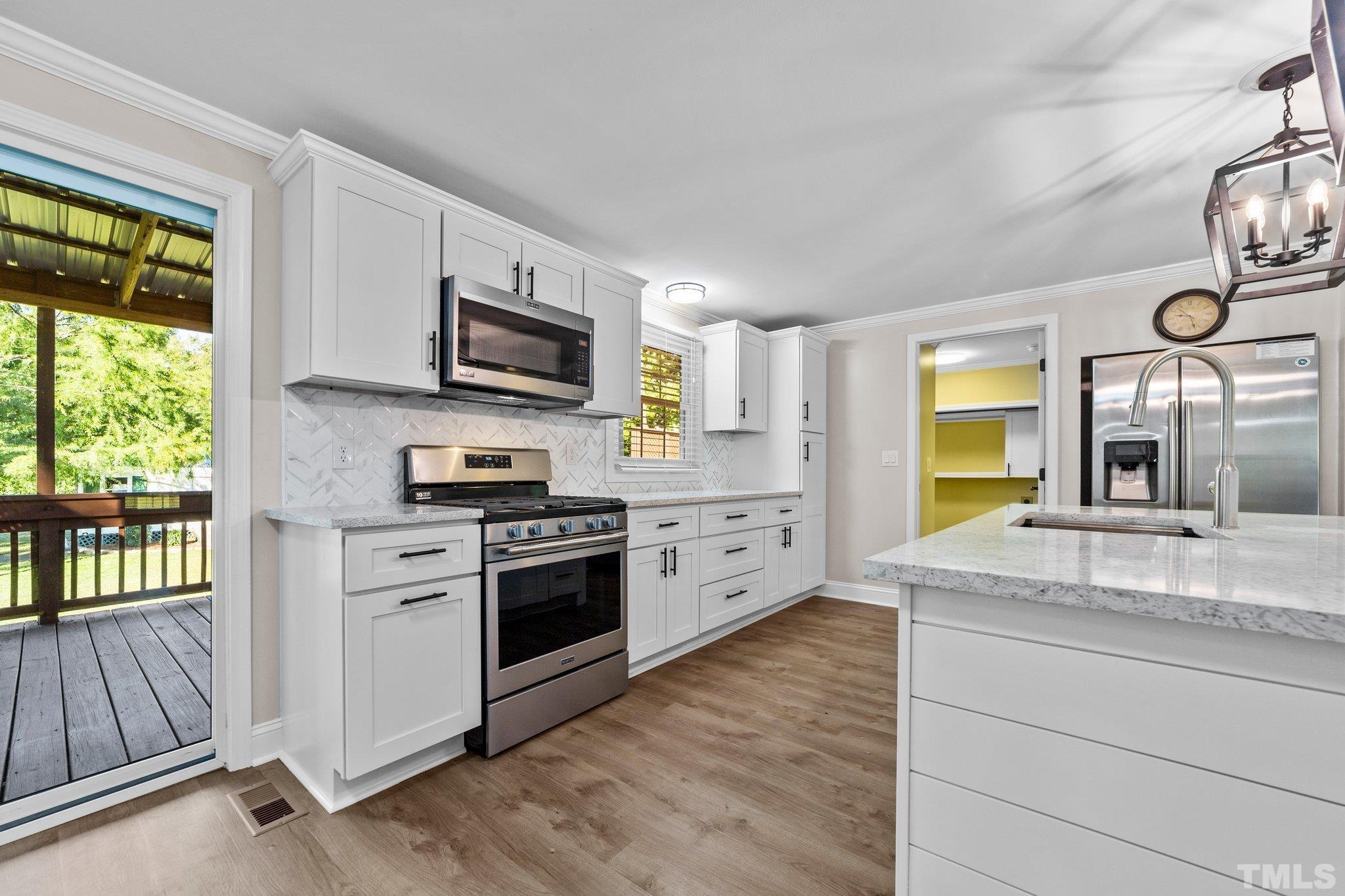 774 Abbott Road Henderson, NC 27537 - Photo 8 of 41 a kitchen with stainless steel appliances granite countertop a stove and a sink