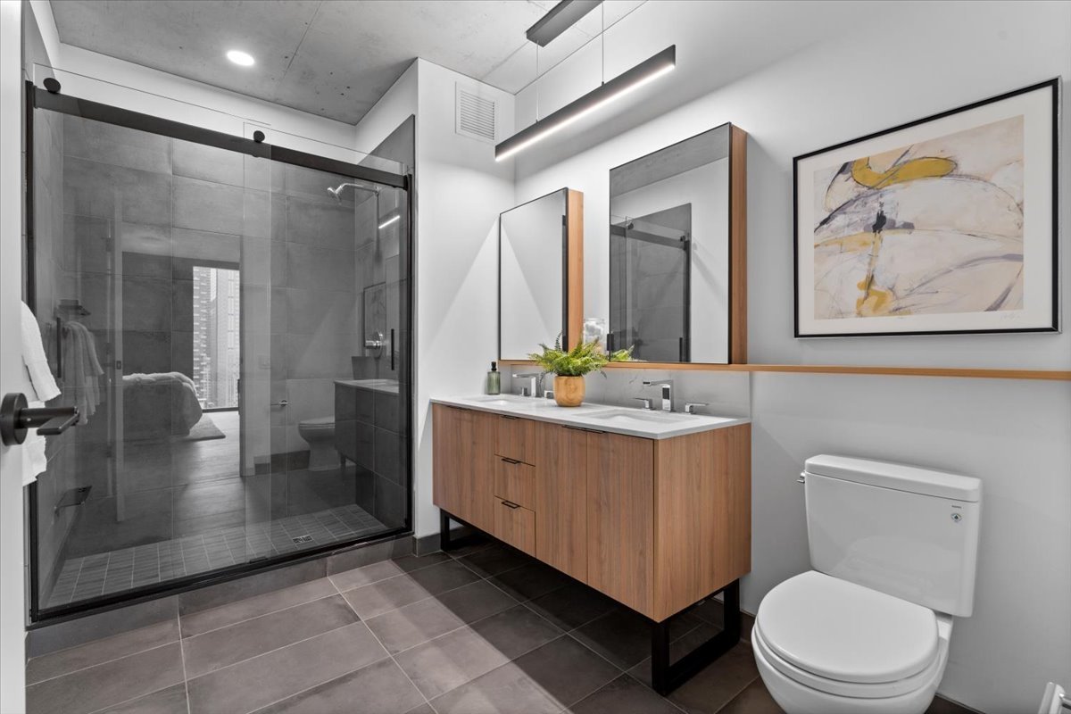 234 West Polk Street, Unit 3612 Chicago, IL 60607 - Photo 17 of 39 a bathroom with a double vanity sink toilet and shower