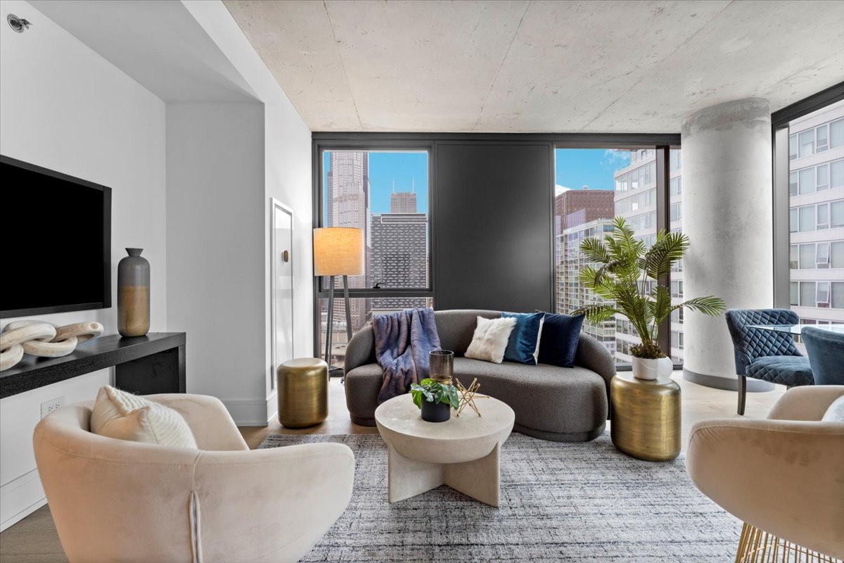 234 West Polk Street, Unit 3612 Chicago, IL 60607 - Photo 5 of 39 a living room with furniture and a flat screen tv