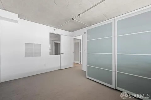 a view of an empty room with closet