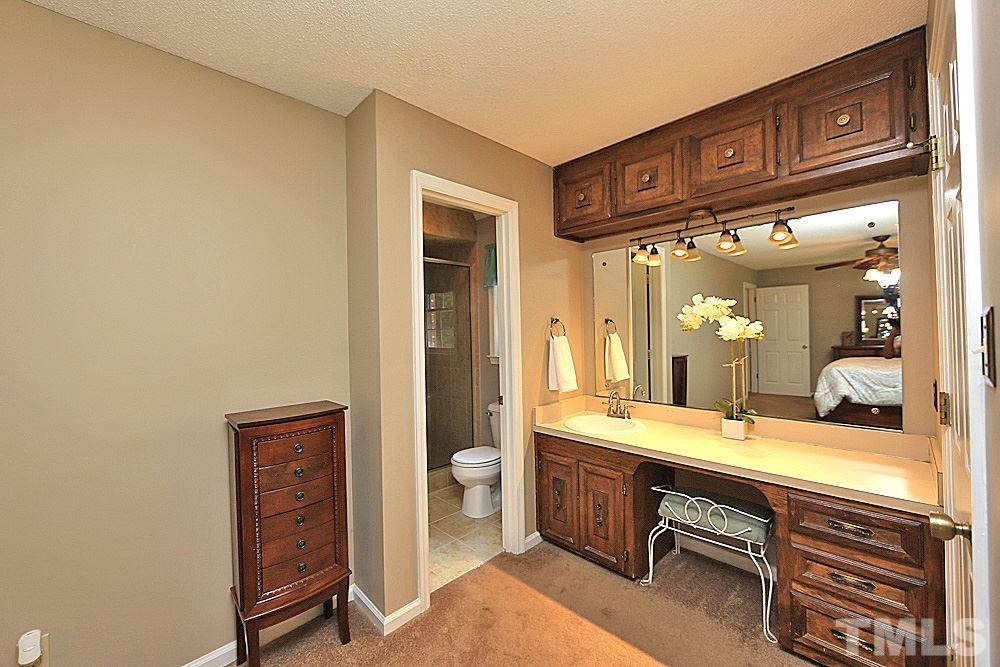 12521 Ghoston Road Wake Forest, NC 27587 - Photo 14 of 30 a bathroom with a sink a mirror and a shower