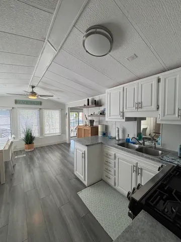 a kitchen with sink cabinets and window